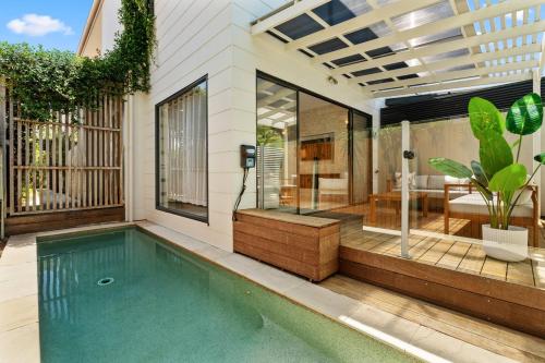 a swimming pool in the backyard of a house at Palm Beach Retreat: Plunge Pool & Coastal Luxe in Gold Coast