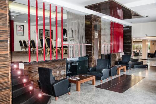 a lobby with chairs and a fireplace and a table at Lioncity Hotel in Bursa