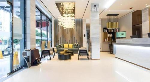 a lobby with a couch and chairs in a building at City Comfort Inn Liuzhou Sanjiang Gulou Bird's Nest in Sanjiang