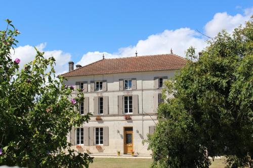 a large white house with a red roof at Logis de L'Arceau in Celles