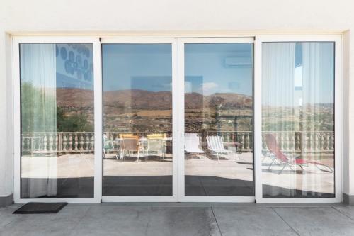 a sliding glass door with a view of a patio at B&B Monterosso in Realmonte