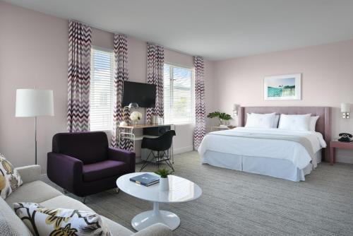 a hotel room with a bed and a couch at The Astor by LuxUrban, Trademark Collection by Wyndham in Miami Beach