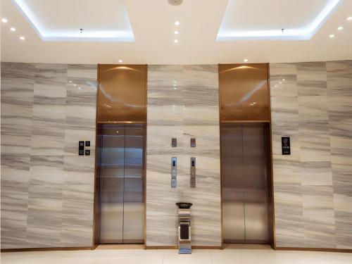 a row of elevators in a building at City Comfort Inn Lingshui Central Avenue Bus Station in Lingshui