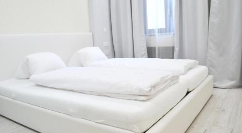 a white couch with two pillows on top of it at Bad Ischl - Central & Quiet Apartment in Bad Ischl
