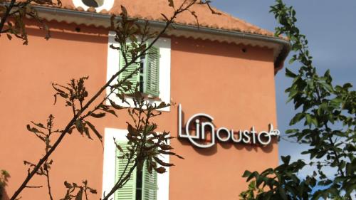 a building with a sign on the side of it at Le Mas du Lingousto in Cuers
