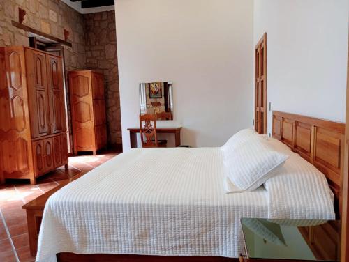 a bedroom with a large white bed in a room at Casa Purépecha, Habitación Itzi in Morelia