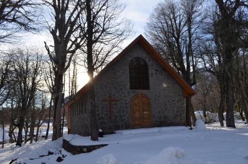 a church with a cross on the front in the snow at Departamento Termas de Chillan in Nevados de Chillan
