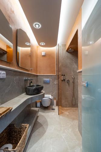 a bathroom with a sink and a toilet and a shower at Green Sea Villas in Skala Potamias