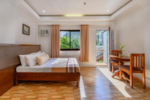 Postel nebo postele na pokoji v ubytování Jurias Garden Hotel