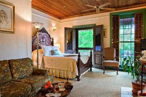 a living room with a bed and a couch at St. Francis Inn - Saint Augustine in Saint Augustine