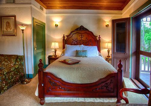 a bedroom with a large bed and a window at St. Francis Inn - Saint Augustine in Saint Augustine