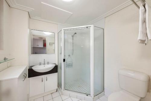 a bathroom with a shower and a toilet and a sink at Shoreline Apartments - Unit 9a in Bargara