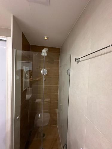 a shower with a glass door in a bathroom at Jubiabá - 1110 A - Net 200 MB in Ilhéus