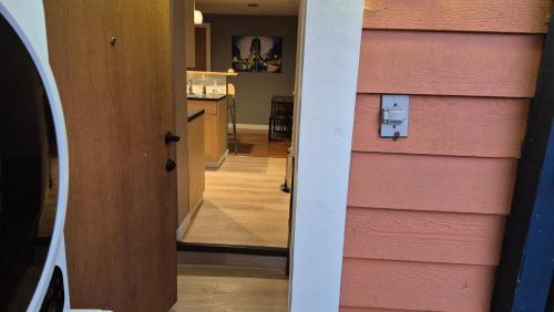 a door to a house with a pink wall at Garden suite on Trinity St in Vancouver
