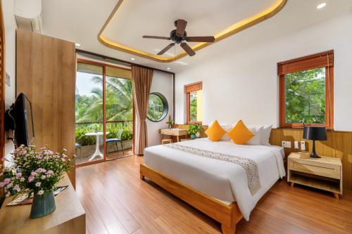 a bedroom with a large bed and a television at An Bang Sunset House in An Bàn (2)