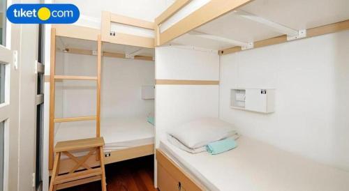 a room with two bunk beds and a ladder at Royal Hostel Singapore in Singapore
