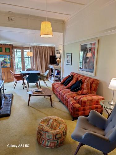a living room with a couch and a table at The Gables - Circa 1880 - Classic Bowral Property in Bowral