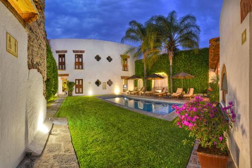 an exterior view of a house with a swimming pool at Alqueria de Carrion Hotel Boutique in Atlixco