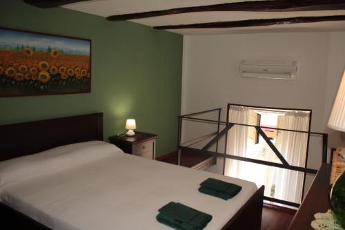 1 dormitorio con 1 cama y una ventana con una pintura en Casa del Girasole en Nápoles