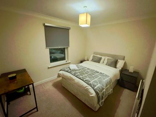 a bedroom with a bed and a window at Clarkson Court in Hatfield
