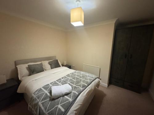 a bedroom with a large bed and a light at Clarkson Court in Hatfield