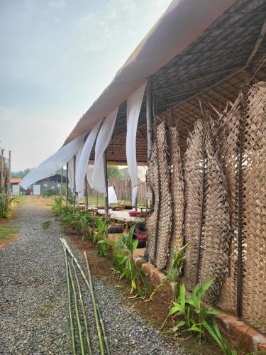 a building with a bunch of umbrellas on it at REWOGA Gaia Resort - Luxury Rooms with Open-Air Shower in Arambol