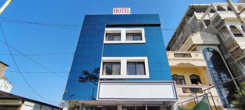 a blue building with a hotel sign on it at Moon palace in Maheshwar