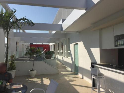 a building with a patio with tables and chairs at Hotel Atlântico Tower in Rio de Janeiro