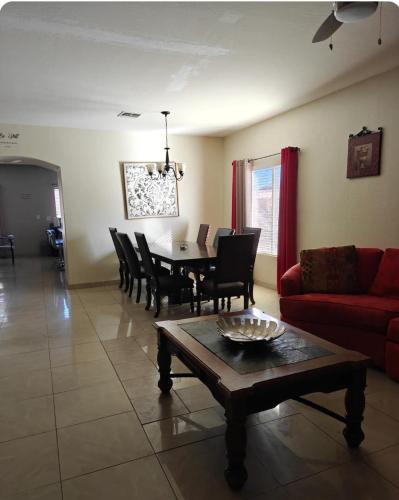 a living room with a table and a red couch at 777 Hopi in Buckeye