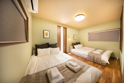 Postel nebo postele na pokoji v ubytování Private House KANADE