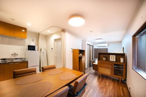 a kitchen and dining room with a wooden table at Private House KANADE in Nara
