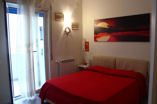 パレルモにあるEsedra B&Bのベッドルーム1室(赤いベッド1台、大きな窓付)