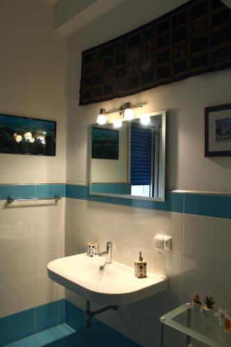 a bathroom with a sink and a mirror at Esedra B&B in Palermo