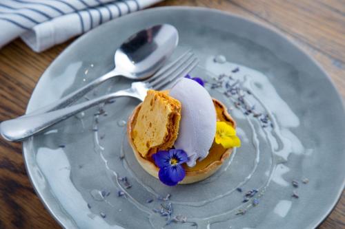 a plate with a piece of bread and a piece of cake at Townhouse Hotel in Wagga Wagga
