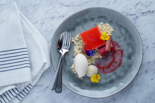 a plate with food and a egg and a fork at Townhouse Hotel in Wagga Wagga