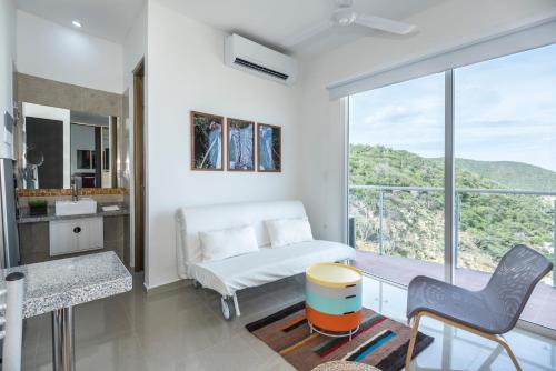 a bedroom with a bed and a table and chairs at Terrazas Tayrona Travelers Apartamentos y Suites in Santa Marta