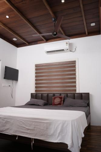 a bedroom with a large bed in a room at Paradise Riviera in Ernakulam