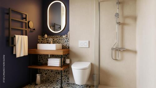 a bathroom with a toilet and a mirror at Hotel 2M, The Originals Relais in Saint-Just-Saint-Rambert