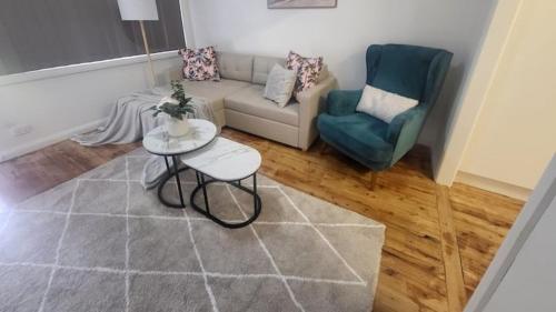 a living room with a couch and two chairs at Family Friendly - 5 Mins To Beach in Belmont