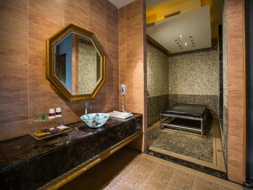 a bathroom with a sink and a mirror at Moon Area Motel in Douliu