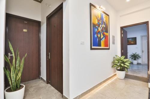 a hallway with two doors and two potted plants at FabHotel Anant Inn in Lucknow