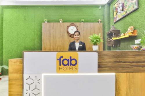 a woman standing behind a podium in a room at FabHotel Anant Inn in Lucknow