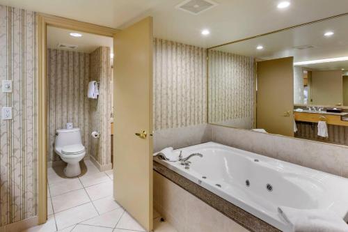 a large bathroom with a tub and a toilet at Carriage Ridge Resort, an Ascend Collection Resort in Oro-Medonte