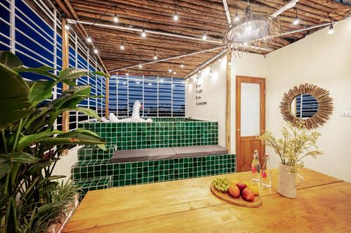 a room with a green tile tub with a table at Urban Horizon Boutique Suites in Hanoi