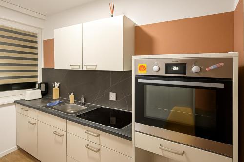 a kitchen with a sink and a microwave at Moderne 3-Zimmer-Ferienwohnung in Emersleben in Halberstadt