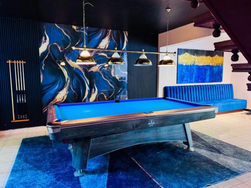 a pool table in a room with a painting at Beverly Beach Mirissa in Mirissa