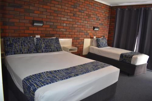 Postel nebo postele na pokoji v ubytování Coorrabin Motor Inn