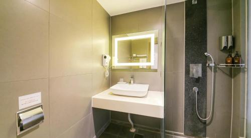 a bathroom with a sink and a shower at Sun Land Hotel Jeju in Jeju