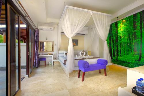 a bedroom with a canopy bed and a purple chair at Lavender Private Villa Kuta Bali in Kuta
