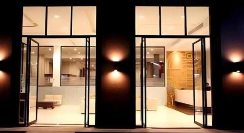 a room with glass doors and a living room at The Regent Ubon in Ban Na Khwai